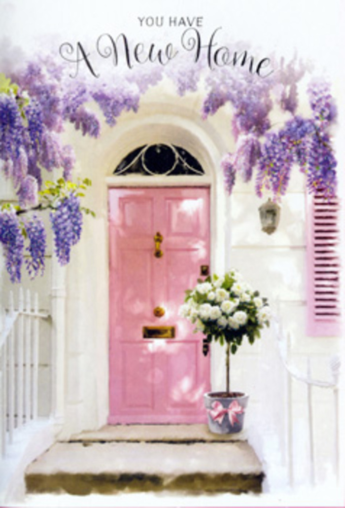 A romantic entrance in Kingston Vale is the focus of this image, where architecture and floristry blend into one harmonious greeting. The doorway itself is marked by a gentle pink door, painted in a soft, powdery hue that feels almost like a watercolour wash against the bright, whitewashed wall. A matching shutter sits nearby, its pastel tone creating a sense of balance and cohesion on the façade. Above, plentiful strands of wisteria drape luxuriously, their long racemes of blossoms blending shades of lavender, lilac, and pale mauve. These tumbling flowers form a loose arch around the entrance, suggesting an almost storybook charm you might spot on a walk between Kingston Vale and the nearby university campus. Their density filters the sunlight, casting fine, speckled shadows that lend the scene a dreamy, slightly hazy serenity. On the doorstep, a chic metal bucket serves as the base for a lush rose arrangement. The bucket's soft grey finish feels understated and modern, allowing the flowers to shine. Inside, creamy white roses bloom in full, each petal layered upon the next to create rich, ruffled cups of colour. Soft green foliage threads through the roses, breaking the palette just enough to feel fresh and natural. Around the bucket's base, a satin ribbon in blush-pink is tied into a loose, flowing bow, its gentle sheen echoing the tones of the door and enhancing the sense of occasion. The overall atmosphere is of quiet joy and warm anticipation, the kind of setting you might associate with a couple collecting their keys for the first time. It speaks perfectly to a housewarming or congratulations arrangement delivered by a local Kingston Vale florist, capturing the emotions of settling into a new home with grace and heartfelt welcome.