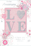 Set against a softly glowing pastel pink background, this anniversary card evokes the intimacy of a Kingston Vale evening shared over memories and smiles. At its heart is the word LOVE, rendered in raised, glitter-touched letters that glimmer in shades of blush pink, creamy white, and silver. The textured finish gives the word a tactile presence, suggesting the comforting touch of a partner's hand. Around this central motif, delicate sprays of illustrated flowers spread out gracefully, their petals softly coloured in blush, mauve, ivory, and pale grey. The blooms are intentionally stylised, like quick, expressive sketches made by a florist while planning a romantic arrangement, their fine outlines and subtle shading adding depth without heaviness. Slender leaves and curling vines weave between the blossoms in gentle arcs, echoing the natural curves of stems in a hand-tied bouquet. Discreet silver highlights catch the light here and there, reminiscent of reflections on the River Thames not far from Kingston Vale. A graceful script message, featuring sentiments such as On Our Anniversary and I love you today and always, winds through the design, the flowing letters harmonising with the floral curves. The composition feels balanced, airy, and deeply affectionate, ideal for marking another year of partnership. Crafted with the same attention to detail that Flower Delivery Kingston Vale brings to its fresh floral pieces, this card is perfectly suited to accompany anniversary flowers delivered locally, creating a complete expression of enduring love and appreciation.